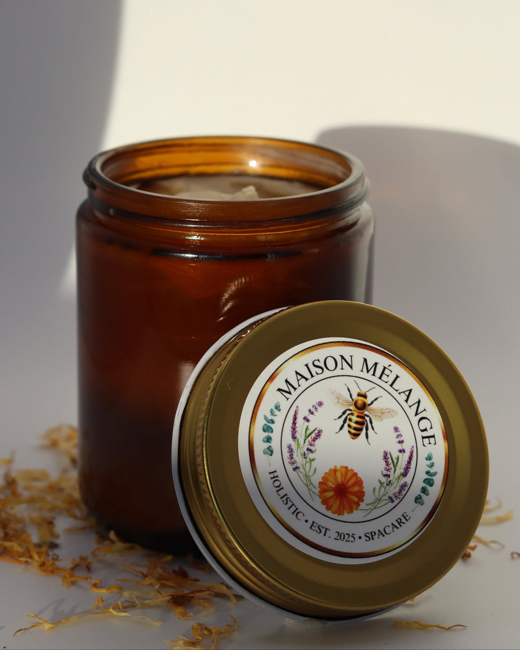 Brown candle jar with 'Maison Melange' label on a white background