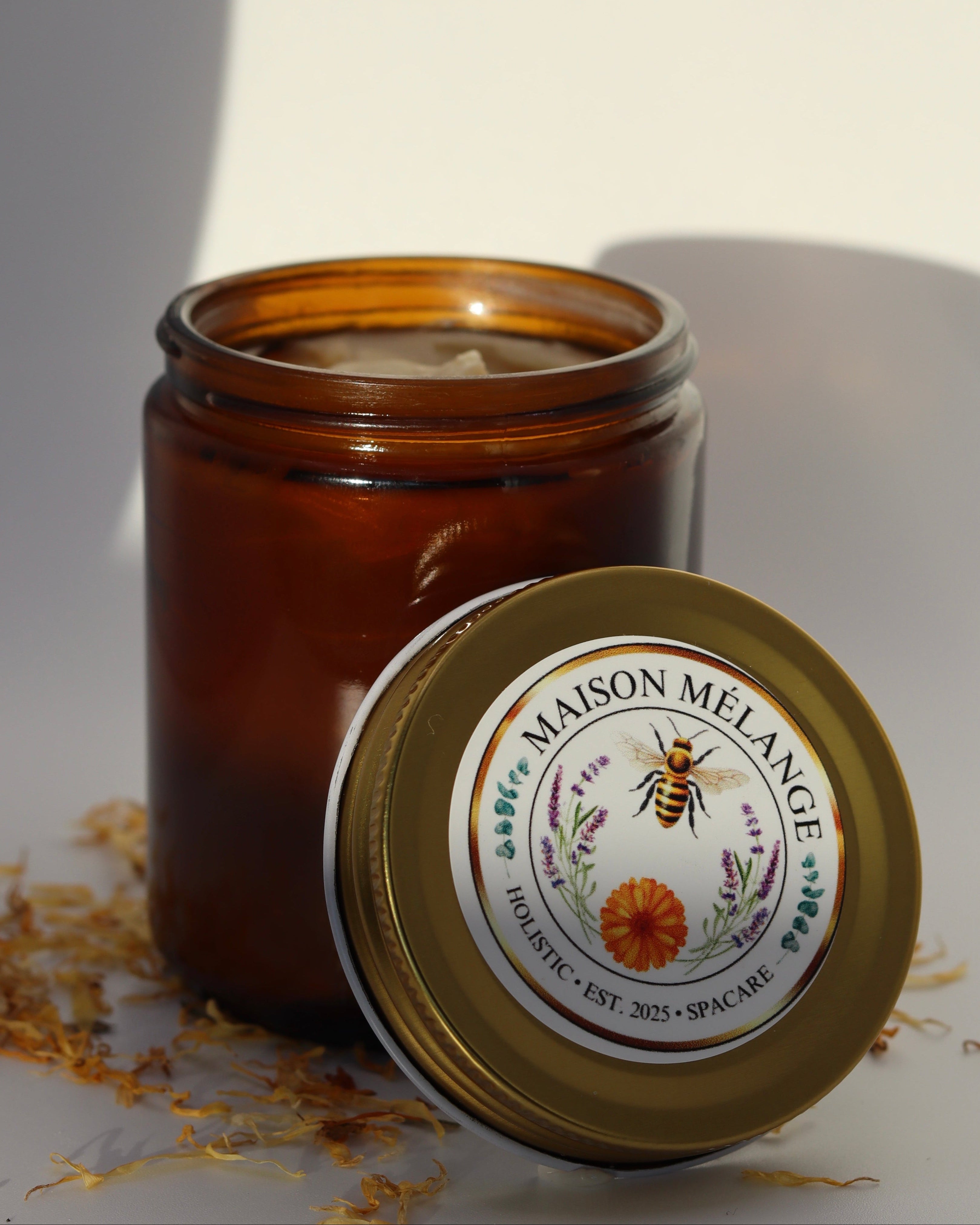 Brown candle jar with 'Maison Melange' label on a white background